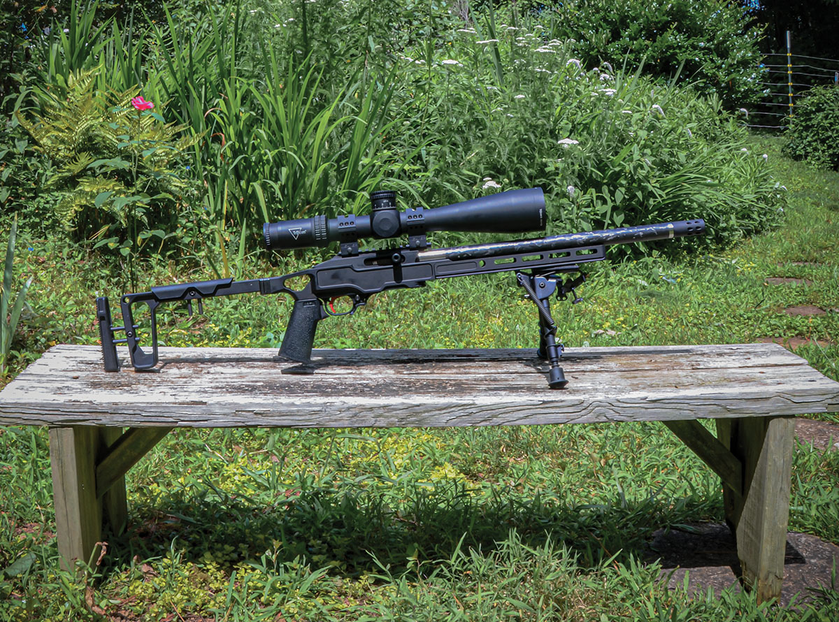 The Ruger Custom Shop Ruger 10/22 Competition with a Trijicon Accupower 5-50x 56mm scope attached to its 30 MOA rail with Weaver 34mm 6-screw rings. When shooting the rifle for accuracy, an M-LOK adaptor from GG&G Tactical was used to attach a Harris bipod.